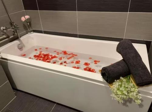 a white bath tub filled with red flowers and stuffed animals at KSL Mall - High Speed WiFi - Bathtub - Netflix - 24-7 Support in Johor Bahru