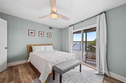 a bedroom with a bed and a ceiling fan at The Roller Coaster River Retreat in Tampa