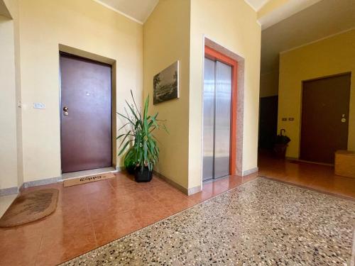 a hallway with two doors and a potted plant at Loving My Rooms 2 - delizioso appartamento in centro in Gorizia