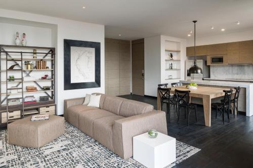 a living room with a couch and a table at 8010 Urban Living- Luxury Home Experience in Bogotá