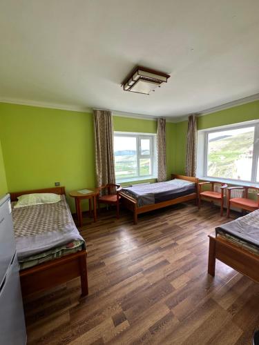 Pokój z 2 łóżkami i zielonymi ścianami w obiekcie Sara's Camp w mieście Dzuunmod