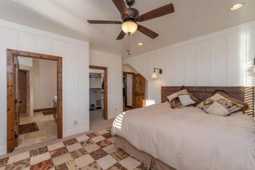 a bedroom with a bed and a ceiling fan at Postcard Views, Teton Valley Id in Tetonia