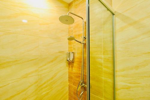 a shower with a glass door in a bathroom at Formosa Spacious Apartments with Netflix & Pick Up Service by MESA in Nagoya
