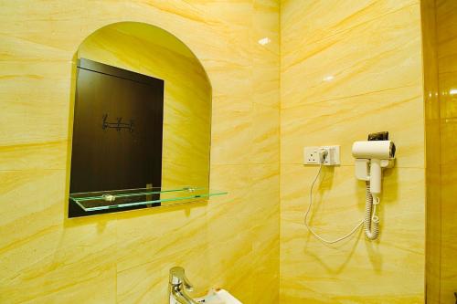 a bathroom with a mirror and a sink at Formosa Spacious Apartments with Netflix & Pick Up Service by MESA in Nagoya
