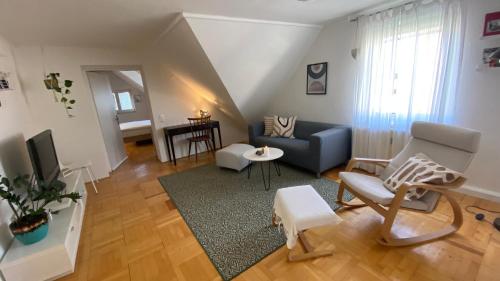 a living room with a couch and a chair at Wohnung am Spitalberg in Klagenfurt