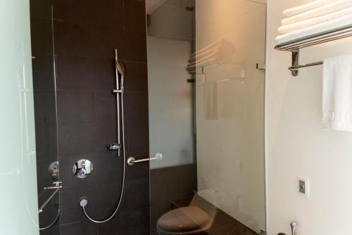 a bathroom with a shower with a toilet at 8010 Urban Living- Luxury Home Experience in Bogotá