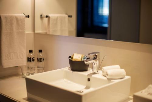a bathroom with a sink and a mirror at 8010 Urban Living- Luxury Home Experience in Bogotá