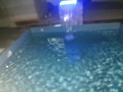 a glass of wine in a pool of water at Villas El Alto 1 in Tambor