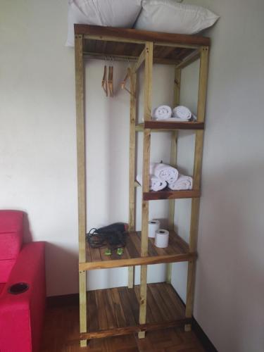 a room with a shelf with towels and a bed at Villas El Alto 1 in Tambor