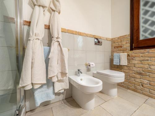 a bathroom with a toilet and a sink at Ollastu Apartments Villasimius in Villasimius