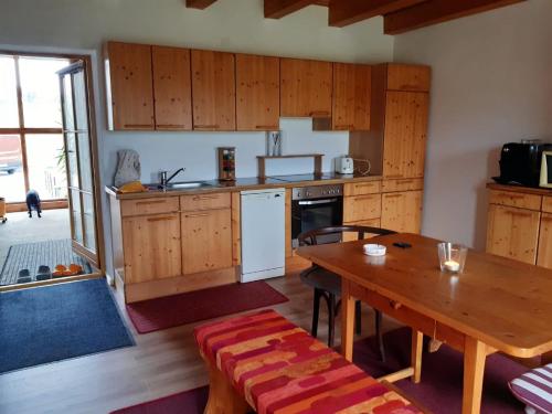 a kitchen with a wooden table and a dining room at Ruhe und Entspannung in Amesedt