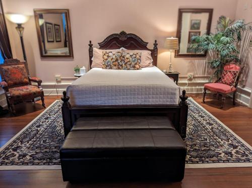 1 dormitorio con 1 cama, 2 sillas y 1 alfombra en The Vistula Rose B & B, en Toledo