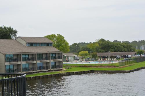a building next to a body of water at The Landing at Seven Coves in Willis