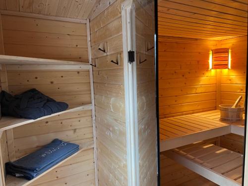 una sauna con paredes y suelos de madera y una lámpara en Reiterbauer Chalet, 