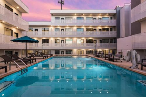 a swimming pool in front of a hotel at GULCH Condo with Pool Gym Private Patio & Garage in Nashville