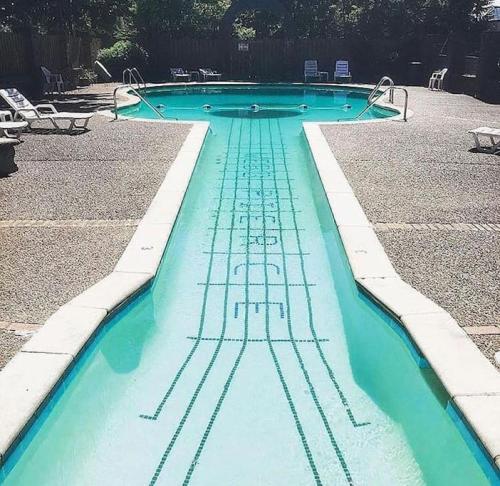 a swimming pool with blue water in the middle at Famous MUSIC ROW 1 Bedroom Condo with FREE Parking and Pool in Nashville
