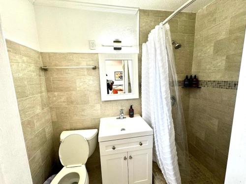 a bathroom with a toilet and a sink and a shower at 2q Suite Apt W Shared Pool - 08 in Clearwater