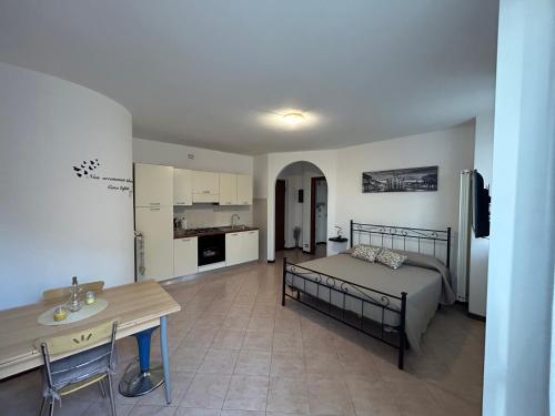 a living room with a bed and a kitchen at AleGio Home in Zelo Buon Persico