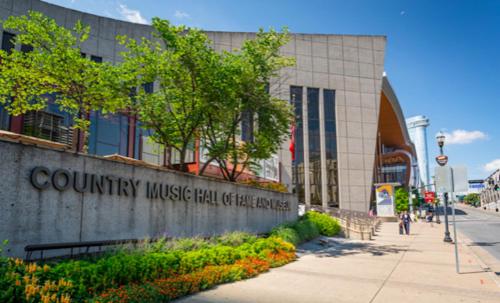 a building with a sign for the country music hall of fame at CHIC Modern Nashville Condo POOL, PATIO, PARKING in Nashville