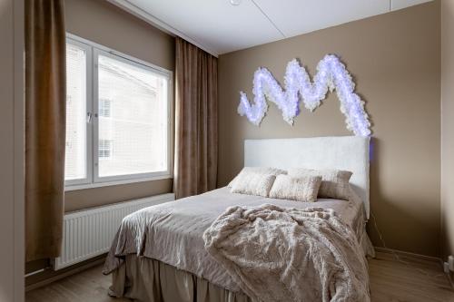 a bedroom with a bed and a window at Cozy Room x Aurora Lights in Tampere