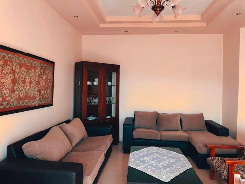 a living room with a couch and a table at Cozy Nook Cottage in Faneroméni