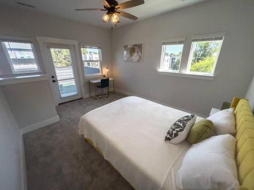 a bedroom with a bed and a ceiling fan at 4 Story Queen City Retreat! New! Walk to Downtown! in Charlotte
