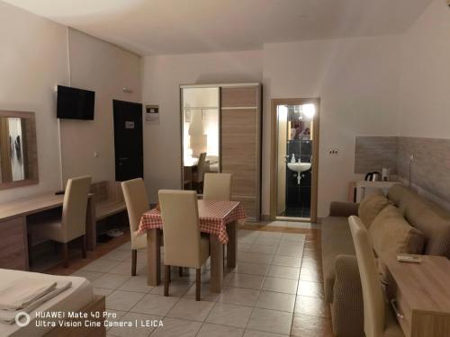 a living room with a table and a couch at Lovely Bosnian Home in Mostar