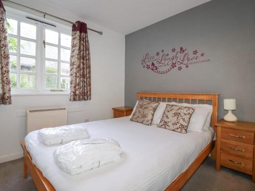 a bedroom with a bed with two towels on it at Minions Cottage in Bodmin