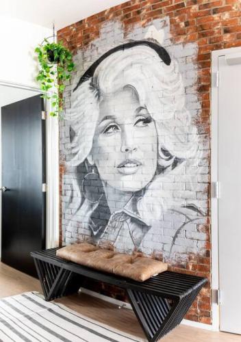 a mural of a woman on a brick wall at Stunning River View Condo Walk to Downtown Rooftop Patio in Nashville