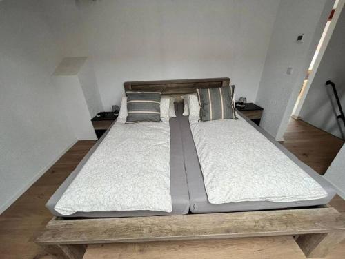 a large bed sitting on a wooden platform in a room at Apartment Mirabelle 5 in Püttlingen