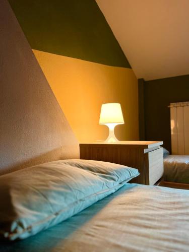 a bedroom with a bed with a lamp on it at Mansarda Moderna in Lunigiana con Giardino in Aulla