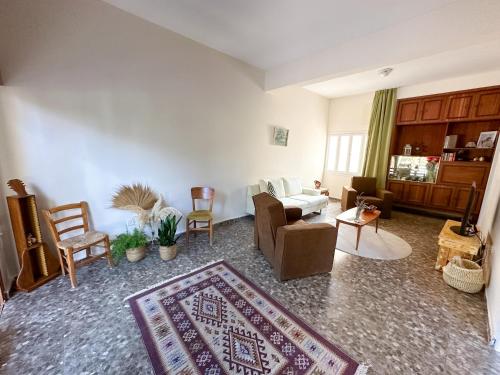 a living room with a couch and chairs and a rug at Varosha View House 