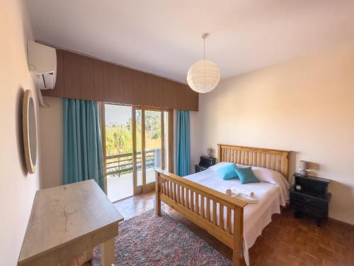 a bedroom with a bed and a large window at Varosha View House 