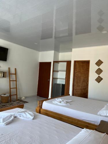 Un ou plusieurs lits dans un hébergement de l'établissement Tintipan Hotel