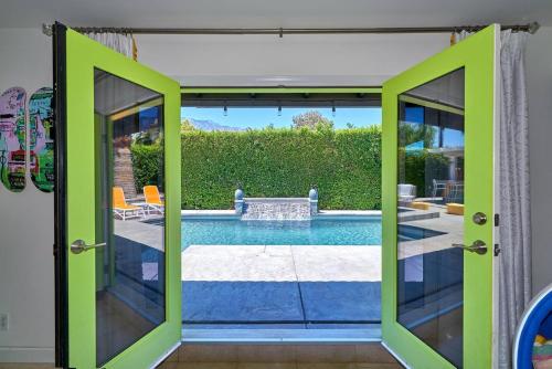 a room with a door open to a swimming pool at Pineapple Splash! Complete Privacy! Salt Pool! in Palm Springs