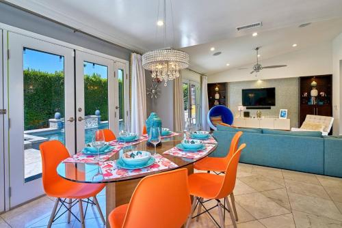 a dining room and living room with a table and chairs at Pineapple Splash! Complete Privacy! Salt Pool! in Palm Springs