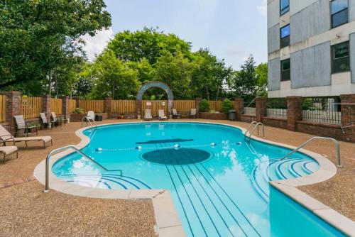 a swimming pool in a yard with a building at Elvis Hotel But Modernized 3 Beds Pool Parking in Nashville