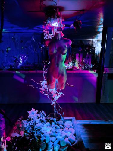 a man standing on top of a table in a room at L'Usine in Belval