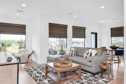 a living room with a couch and a table at Penthouse River View Walk Downtown, Garage Parking in Nashville