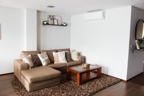 a living room with a couch and a coffee table at Apartament F&M in Braga
