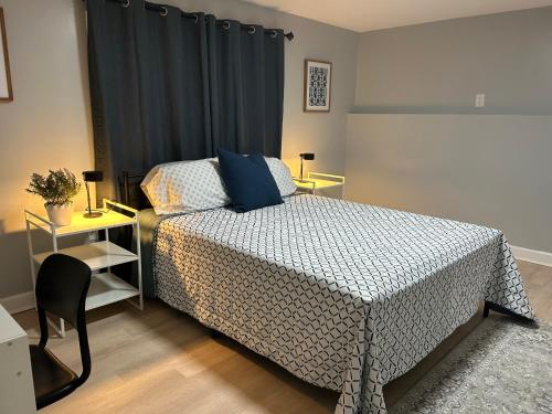 a bedroom with a bed and a table and a chair at Comfy Lower Lvl Apt with Jetted Tub Near Uptown and UNC in Charlotte