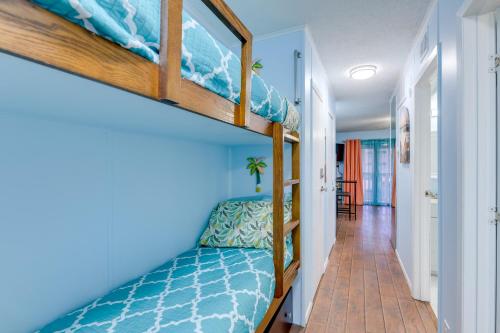 a room with two bunk beds and a hallway at Corpus Christi Condo with Balcony and Beach Views! in Corpus Christi
