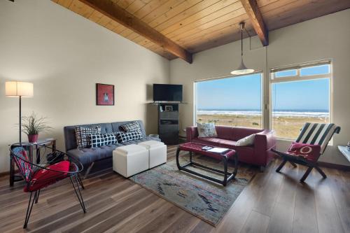 a living room with a couch and a table and chairs at The Tides by the Sea in Seaside