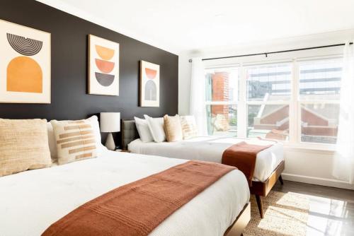 a bedroom with two beds and a window at Stylish Downtown Nashville 3 Beds, 1 Bedroom with Private Patio, Parking in Nashville