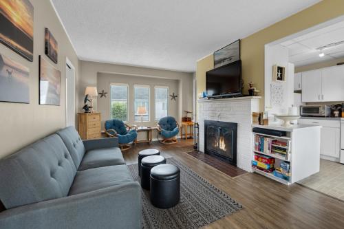 a living room with a couch and a fireplace at The Tides by the Sea in Seaside