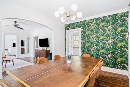 a dining room with a table and a floral wallpaper at Charming House 5 Minutes to Downtown Chattanooga and Aquarium in Chattanooga