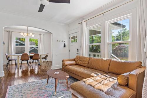 a living room with a couch and a table at Charming House 5 Minutes to Downtown Chattanooga and Aquarium in Chattanooga