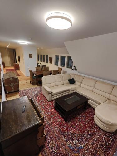 a living room with a couch and a table at Ferienwohnungen - barrierefrei - im sanierten Gutshof in Lalendorf