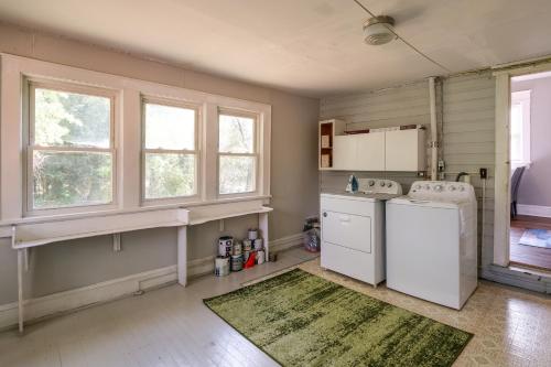 a kitchen with a washer and dryer and two windows at Cozy Roanoke Vacation Rental 2 Mi to Downtown! in Roanoke