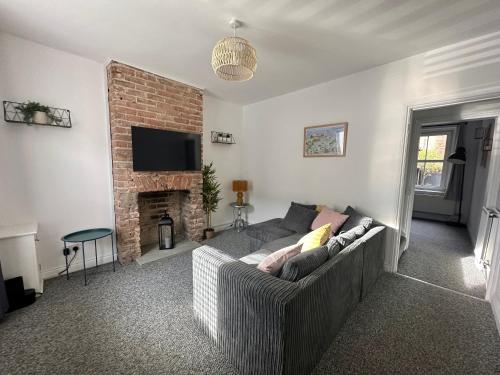uma sala de estar com um sofá e uma lareira em Waterloo Street em Kings Lynn